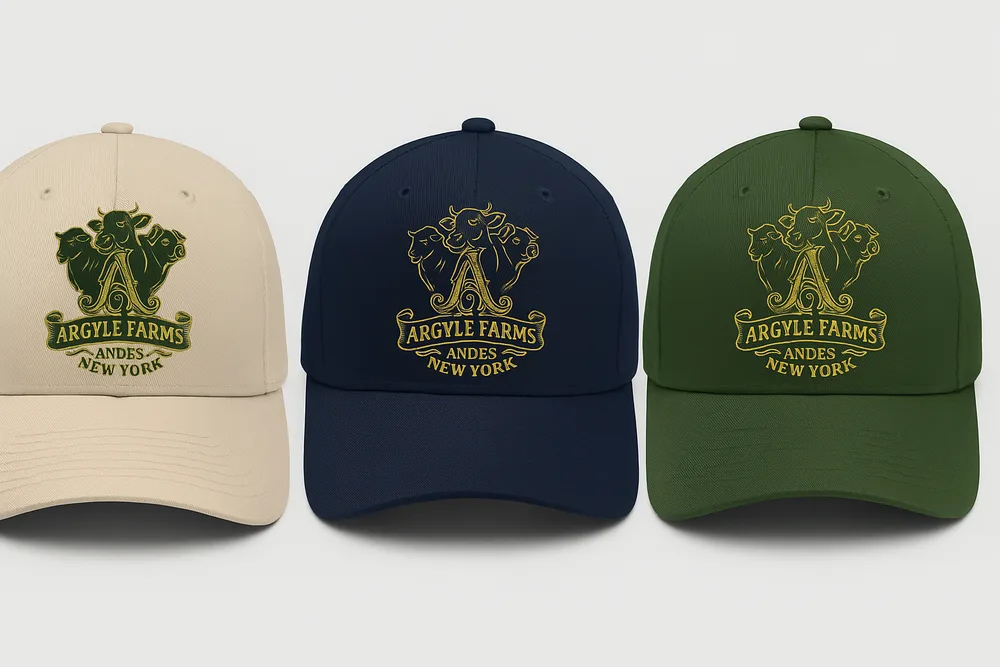 Four cap colorways — black, sand, navy and forest — each with the gold crest